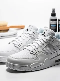 Stylish streetwear sneakers with cleaning tools in the background, emphasizing care.