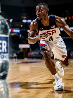 Basketball player on court, sweat visible, with a water bottle, highlighting the need for hydration for peak performance.